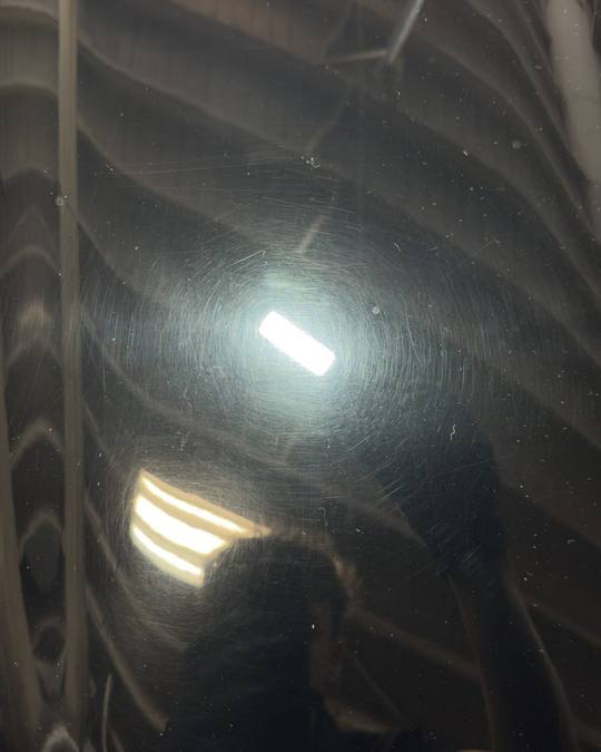 Corvette paint under an inspection light before correction, showing swirl marks