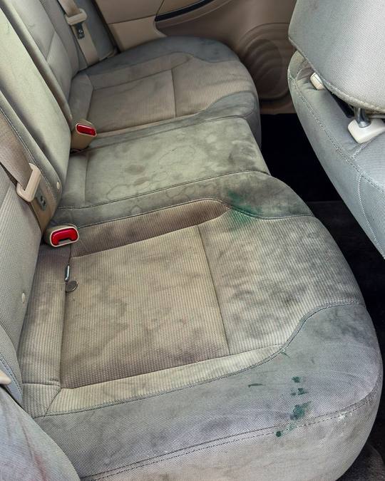 Stained cloth rear seat before an interior detail