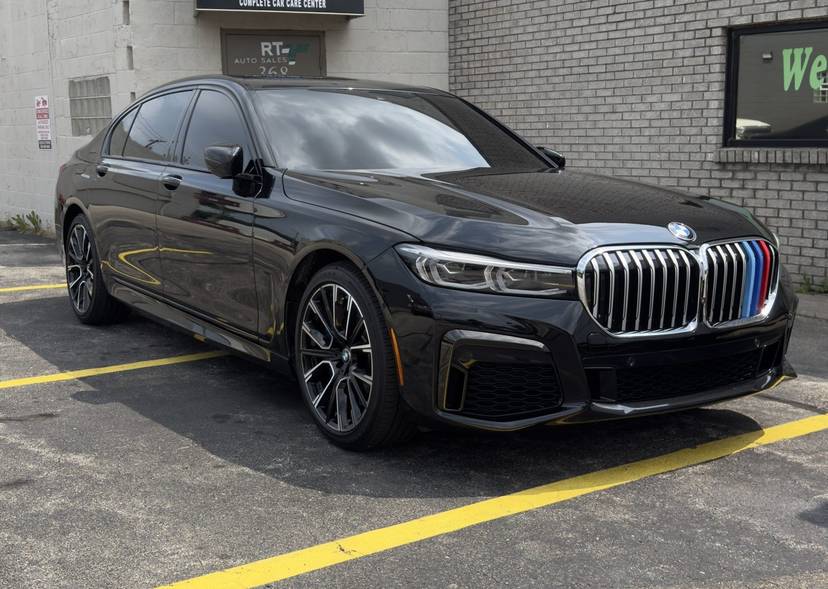 Dark gray BMW sedan parked outside the shop