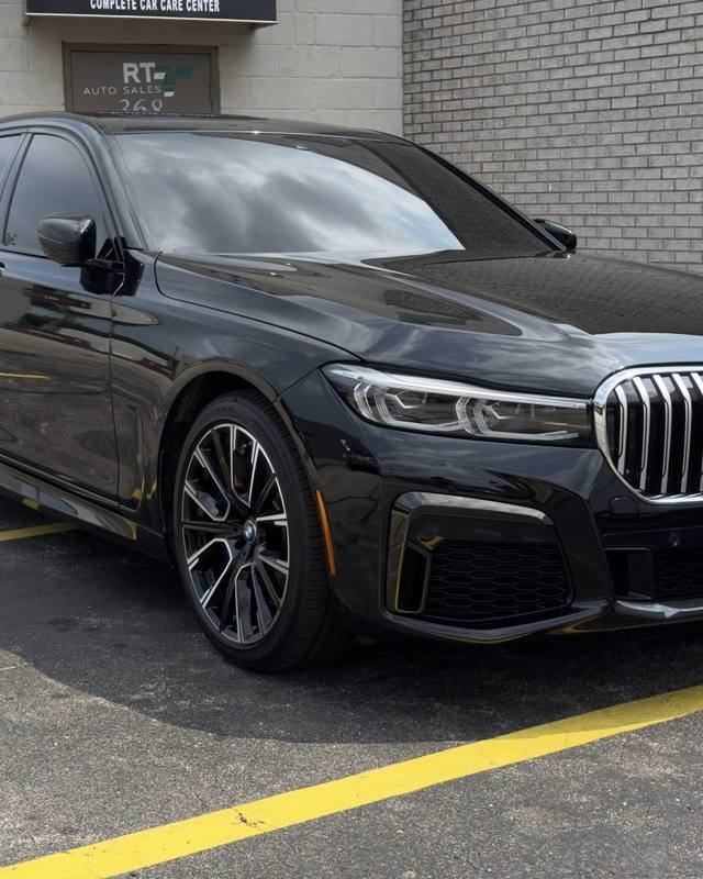 Dark gray BMW sedan parked outside the shop