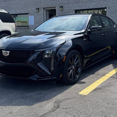 Black Cadillac sedan outside the shop