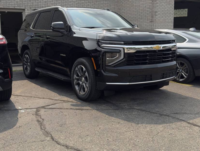 Black Chevrolet SUV outside the shop