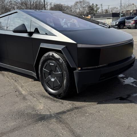 Black Tesla Cybertruck parked outside