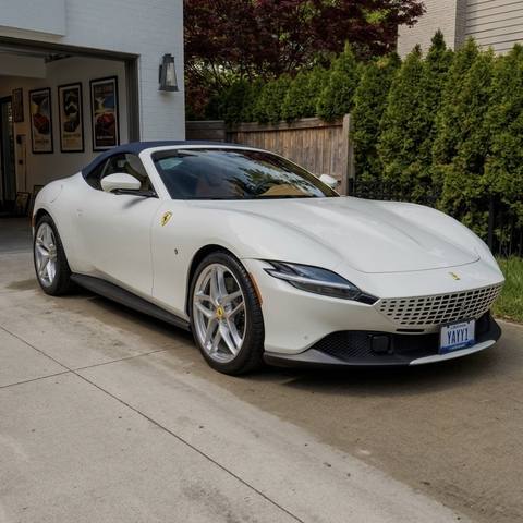 White Ferrari Roma in a driveway after ceramic coating