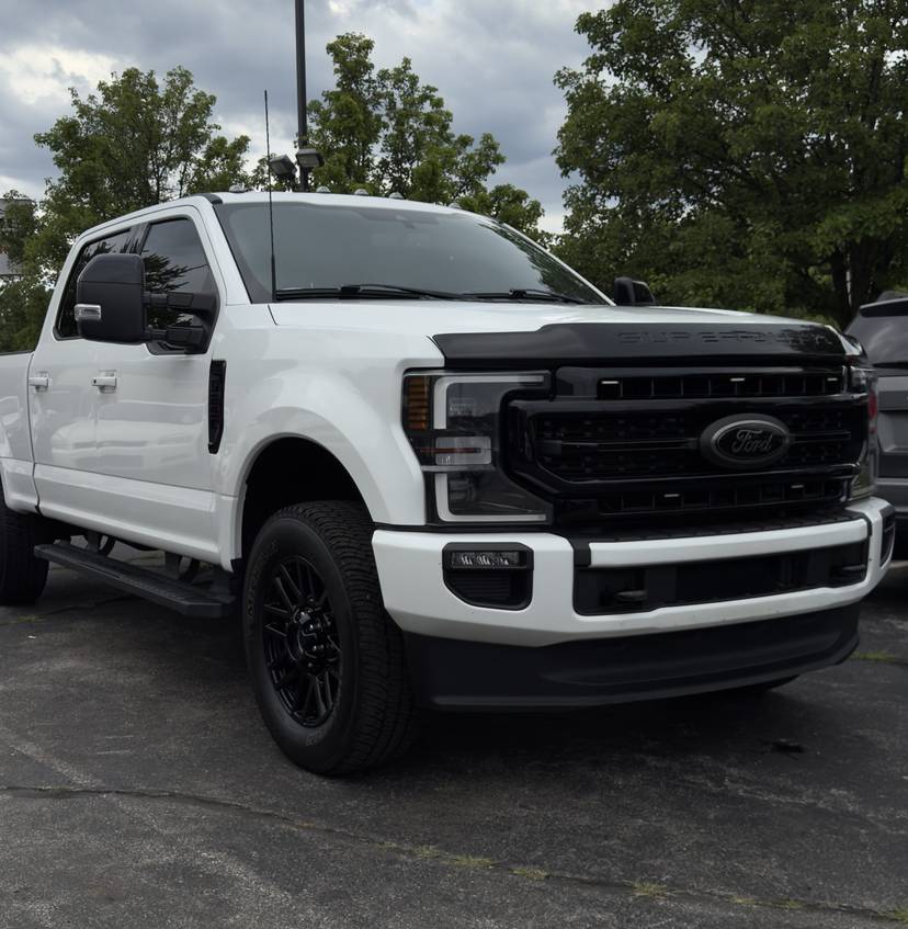 White Ford pickup with black wheels