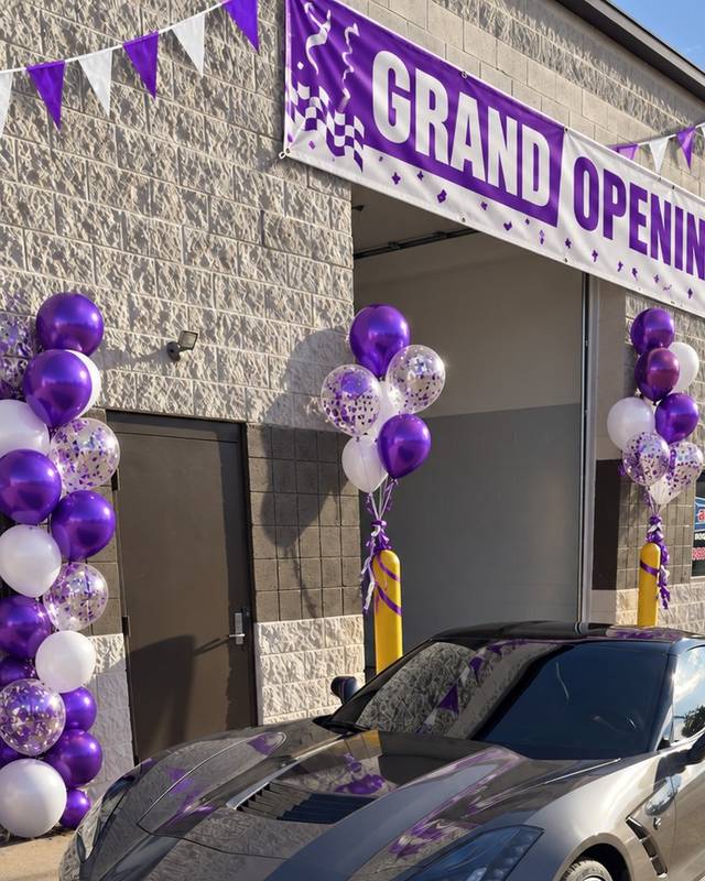 The Refresh My Ride shop front with a grand opening banner, purple balloons and a gray Corvette