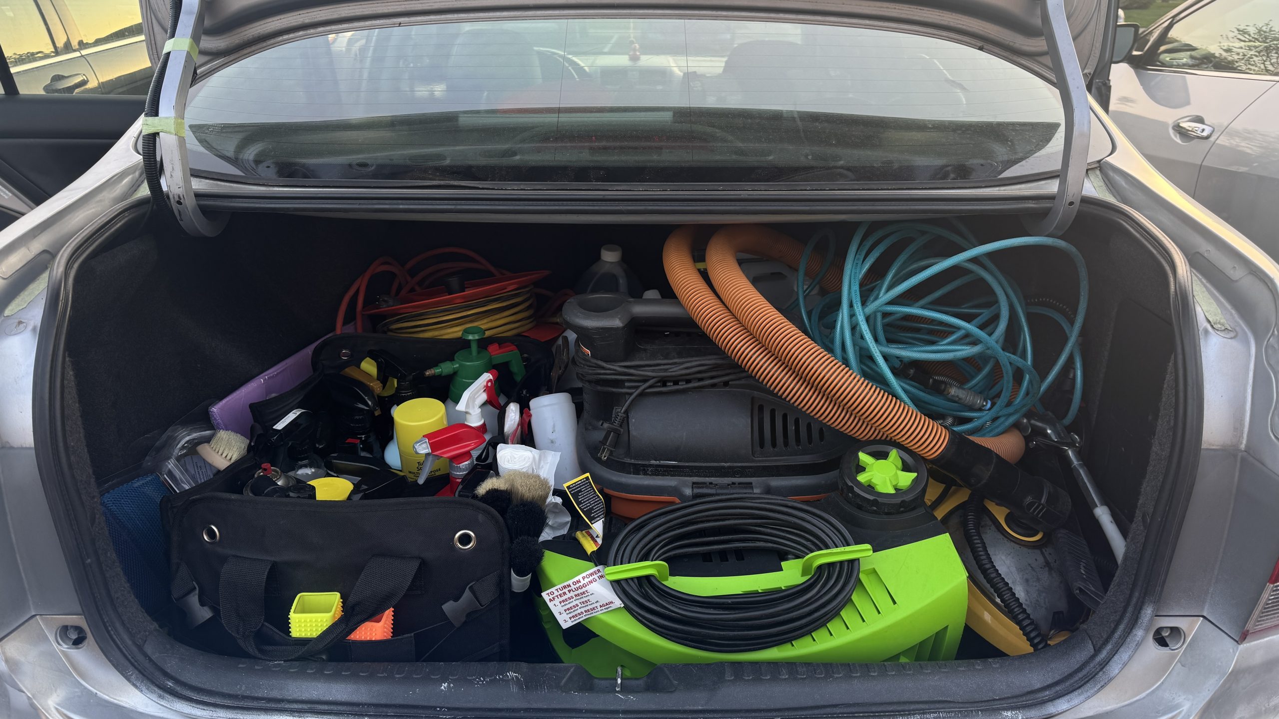 Detailing equipment packed into the trunk of a 2004 Honda Accord in the early days of Refresh My Ride